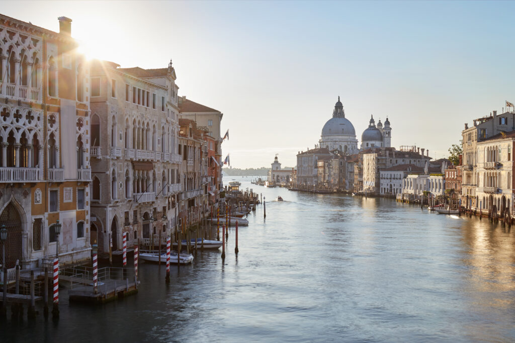 Grand Canal in Venice with Saint Mary of Health basilica, sun in Italy